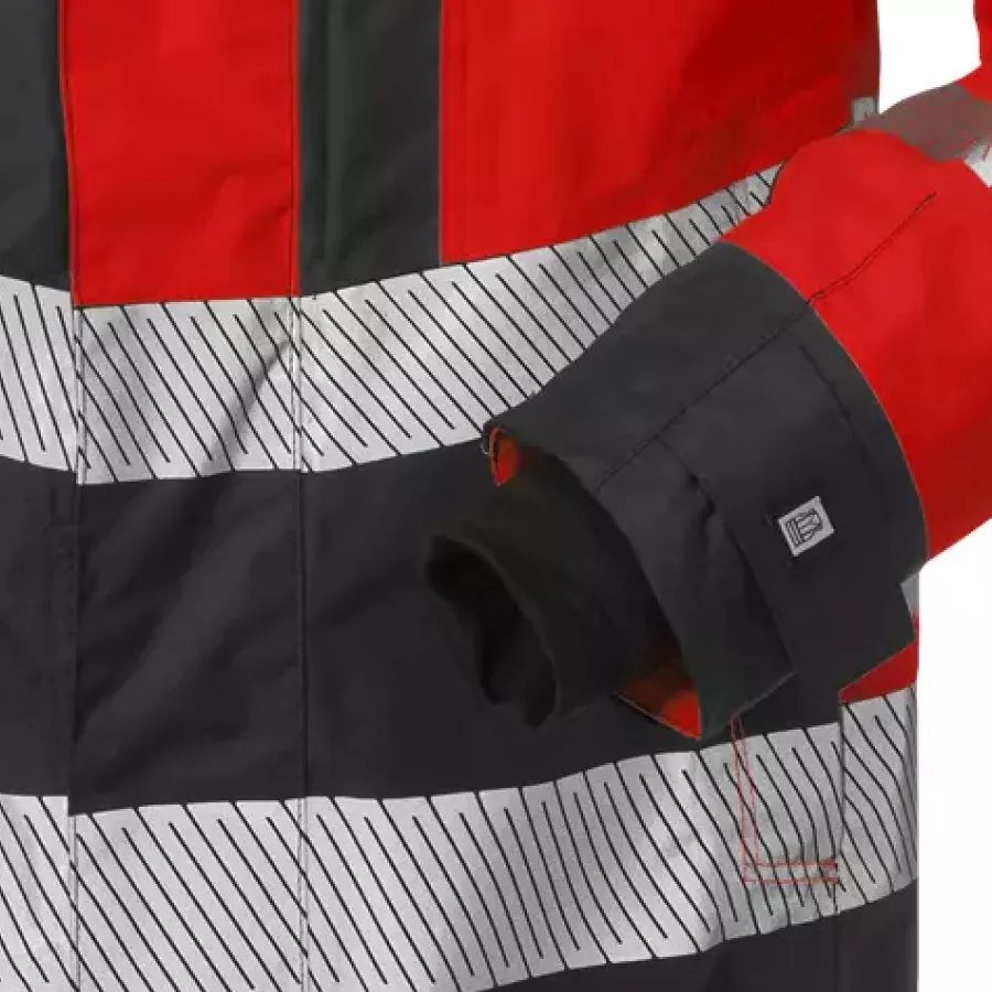 **Mit Klettverschluss verstellbare Ärmel mit Daumengriff** gewährleisten einen sicheren, anpassbaren Sitz, der bei aktiver Arbeit nicht verrutscht.