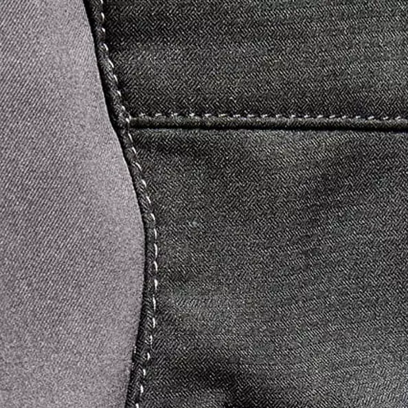 Constructed from a **lightweight, ripstop-woven softshell fabric** (100% polyester, 2-layer, 255 g/m²) that is **wind-resistant and water-repellent**. The durable ripstop weave offers enhanced tear resistance, balancing *comfort and agility* with a robust design suitable for daily wear across various light-duty applications.