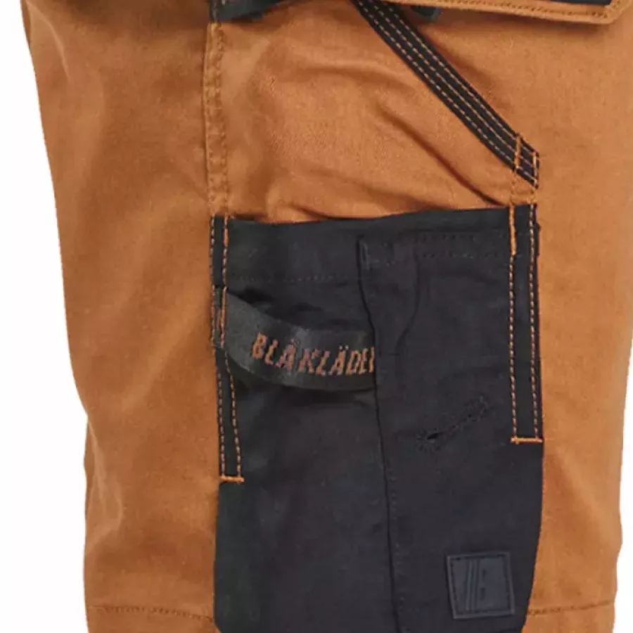 **Reinforced Ruler Pocket with Knife Holder** provides added durability and secure tool placement.