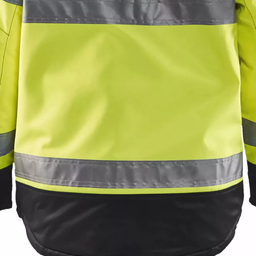 **Verlängerter Rücken** bietet zusätzliche Abdeckung und Wärme, besonders beim Bücken oder Arbeiten im Freien.