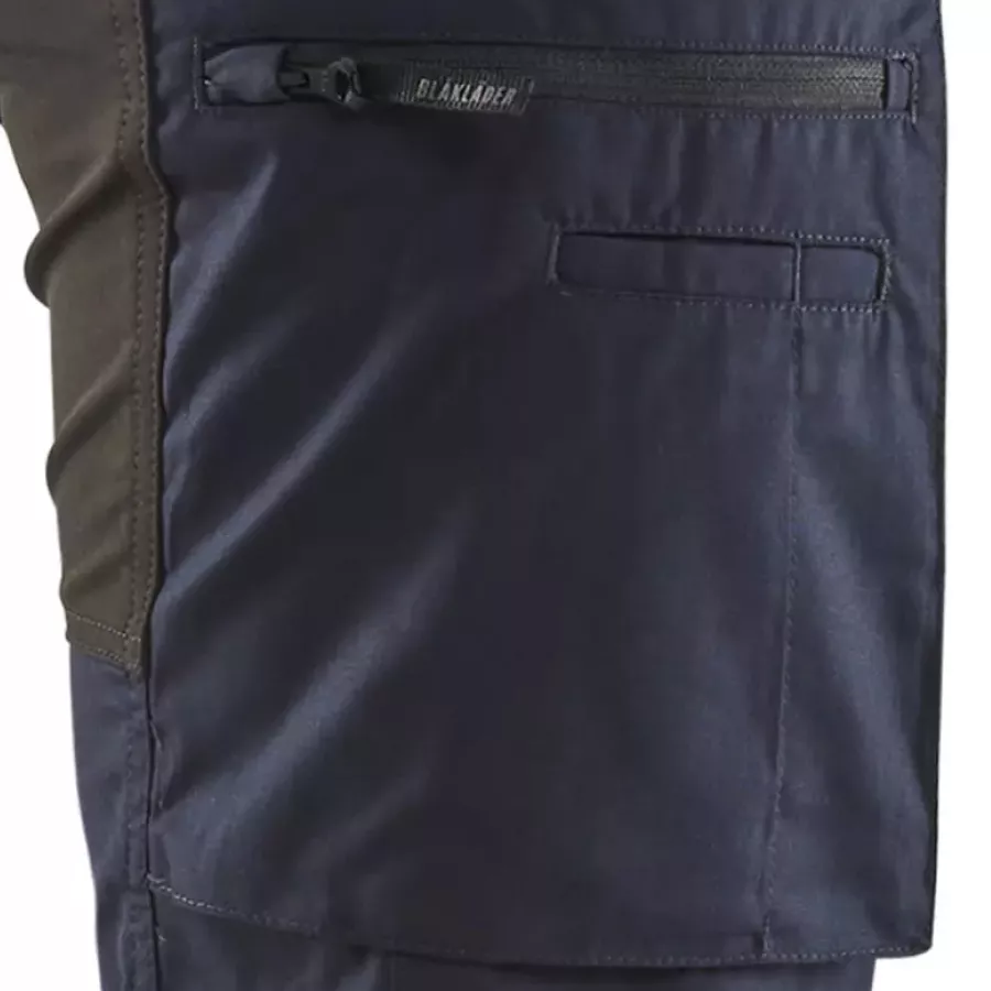 **Zippered Thigh Pockets** keep your essentials safely within reach without breaking your flow.