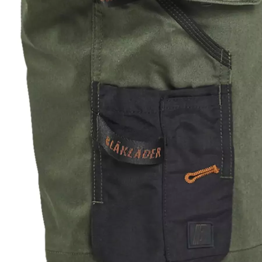 **Reinforced Ruler Pocket with Knife Holder** provides added durability and secure tool placement.